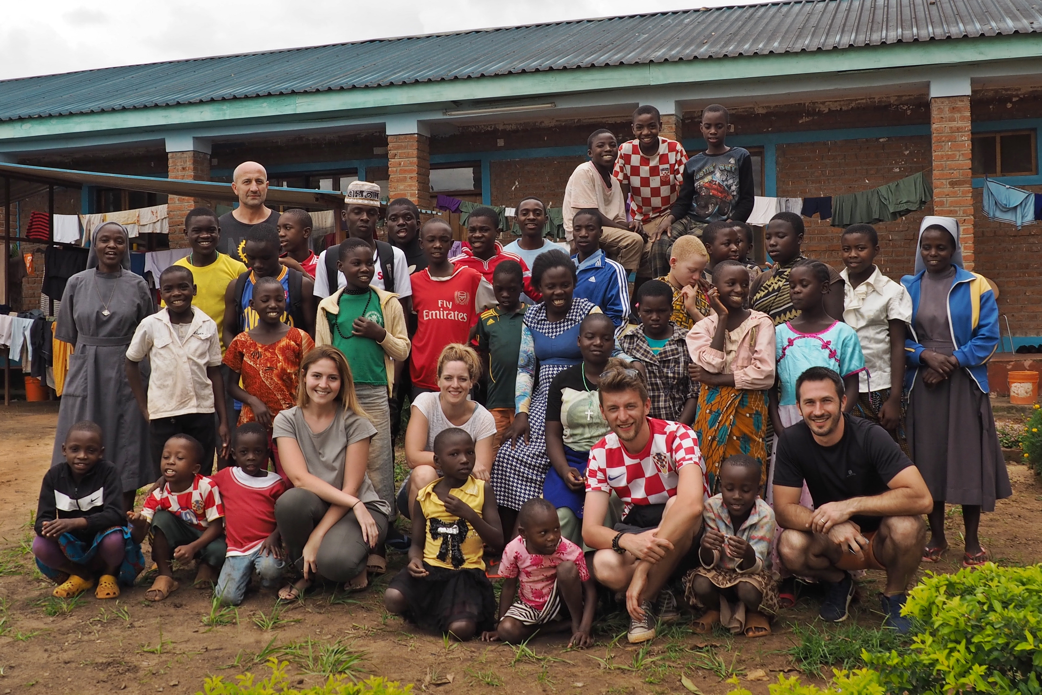 Image with volunteers and kids.