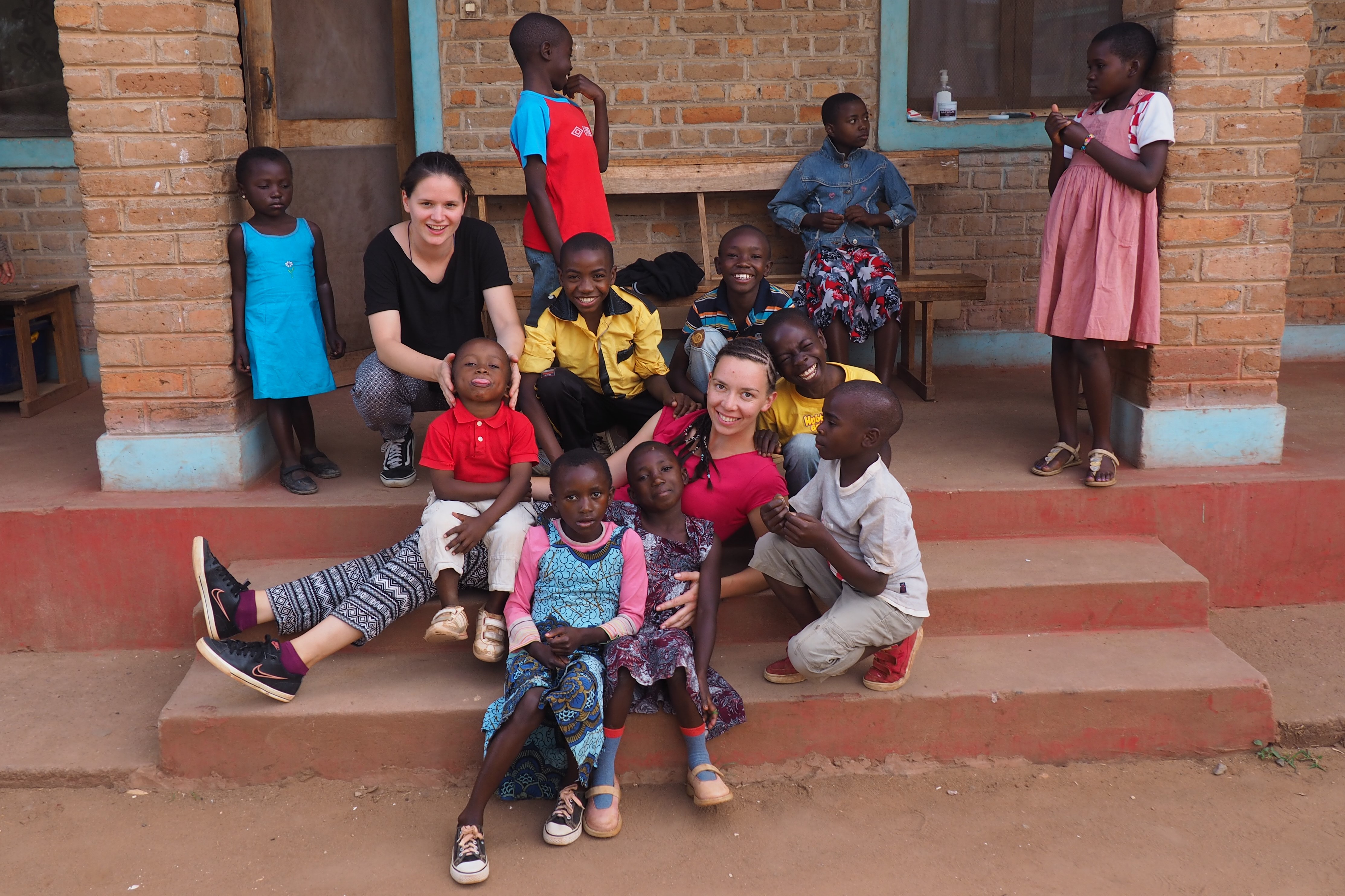 Image with volunteers and kids.